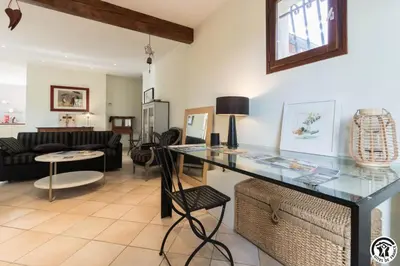 a living room with a glass table and a couch at La maison imart in Revel