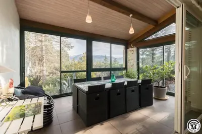 a living room with a large window and a sink at La maison imart in Revel