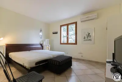 a bedroom with a bed and a window and a television at La maison imart in Revel