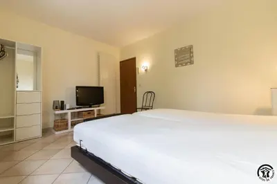 a bedroom with a large white bed and a television at La maison imart in Revel