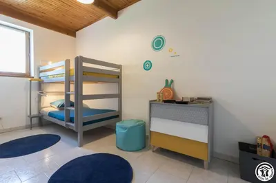 a bedroom with two bunk beds and a desk at La cajole in Montgaillard-Lauragais