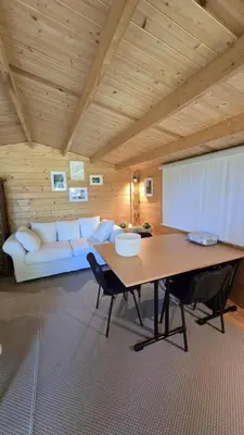 a living room with a white couch and a table at Gîte Domaine de la Fée de l'Eau – L'Eau d'Ô in Saint-Félix-Lauragais