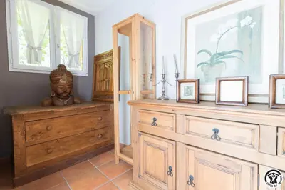 a room with a wooden dresser and a mirror at Domaine de la fee de l'eau - les fees de l'o in Saint-Félix-Lauragais