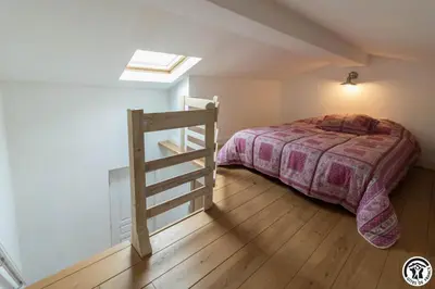 a bedroom with a bed and a ladder at Domaine de la fee de l'eau - les fees de l'o in Saint-Félix-Lauragais
