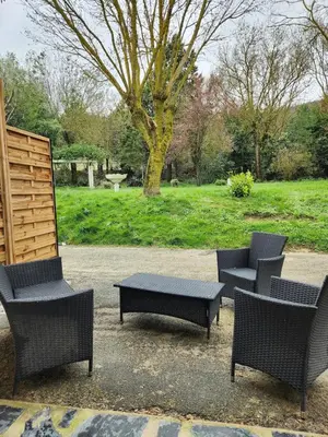 a group of chairs and a table in a park at Appartement refait à neuf in Villeneuve-la-Comptal