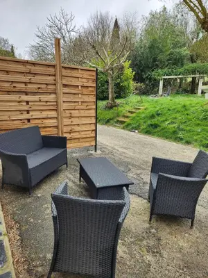 a group of chairs and tables and a fence at Appartement refait à neuf in Villeneuve-la-Comptal