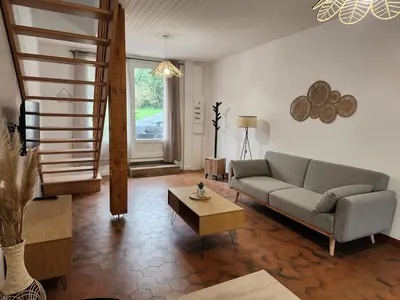 a living room with a couch and a coffee table at Appartement refait à neuf in Villeneuve-la-Comptal
