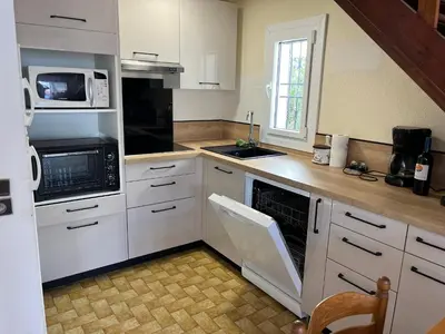 a kitchen with white cabinets and a stove top oven at Villa Climatisée 6 Pers - Proche Port & Village - Parking Privé - FR-1-796-88 in Gruissan