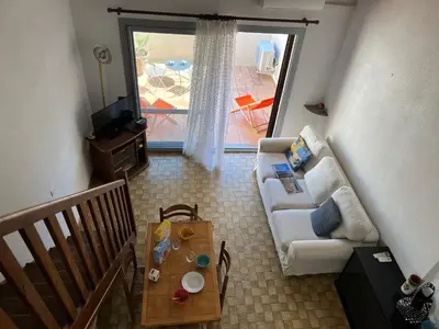a living room with a couch and a table at Villa Climatisée 6 Pers - Proche Port & Village - Parking Privé - FR-1-796-88 in Gruissan
