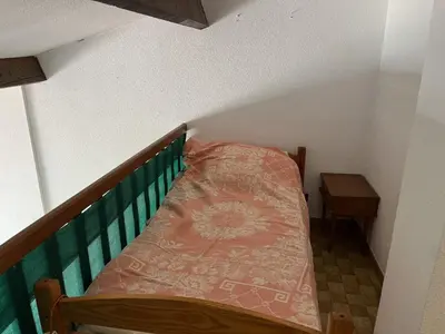a small room with two beds on a staircase at Villa Climatisée 6 Pers - Proche Port & Village - Parking Privé - FR-1-796-88 in Gruissan