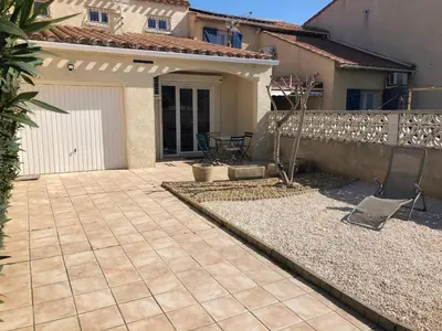 a patio in front of a house at Maison T5 110m² avec jardin clos, près de la plage, animaux acceptés, parking - FR-1-797-64 in Port-la-Nouvelle