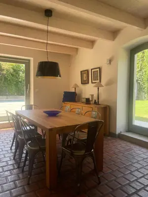 a dining room with a wooden table and chairs at Maison Standing - Exceptionnel in Roquefort-des-Corbières