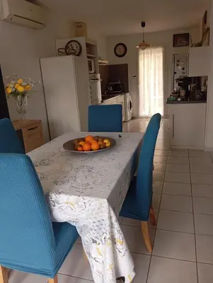 a kitchen with a table with a bowl of oranges on it at Chez Lia in Rieux-Minervois