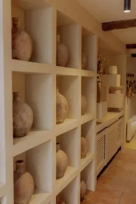 a room with shelves filled with vases at Cozy And Refined Retreat In The Heart Of Fanjeaux in Fanjeaux