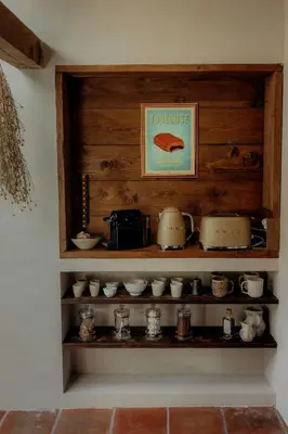 a shelf filled with pots and pans on a wall at Cozy And Refined Retreat In The Heart Of Fanjeaux in Fanjeaux