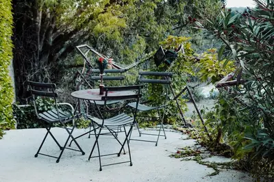 three chairs and a table and a table and chairs at Artistic Loft Near Carcassonne in Cavanac