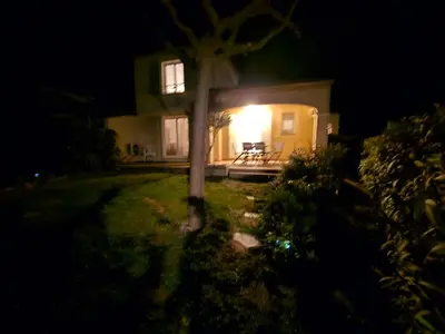 a house with a light on the front of it at night at Logis de Gaia YourHostHelper in Homps
