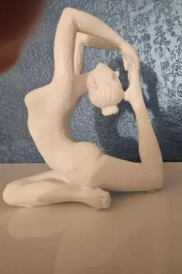 a white statue of a person sitting down with their head in their hands at Logis de Gaia YourHostHelper in Homps