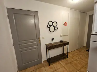 a room with a door and a table next to a door at Logis de Gaia YourHostHelper in Homps