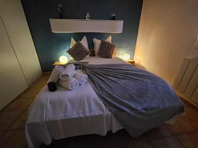 a bedroom with a bed with two stuffed animals on it at Logis de Gaia YourHostHelper in Homps