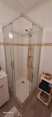 a shower with a glass enclosure in a bathroom at Maison Calme au Centre du Village in Puisserguier