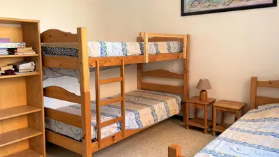 a room with two bunk beds and a bed at Appartement 2 pièces PORT LA NOUVELLE PN015-003 in Port-la-Nouvelle