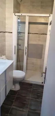 a bathroom with a toilet and a shower and a sink at Appartement 2 pièces PORT LA NOUVELLE PN015-003 in Port-la-Nouvelle