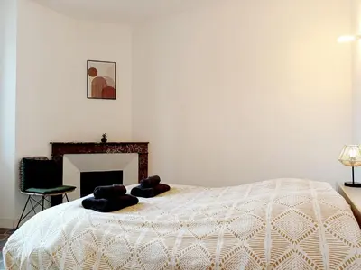 a bedroom with a bed with two pillows on it at Kalipay - 7 min à pied des Grands Buffets in Narbonne