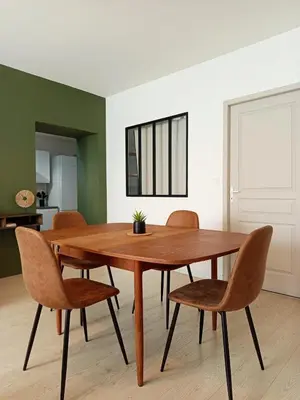 a living room with a table and a couch at Kalipay - 7 min à pied des Grands Buffets in Narbonne