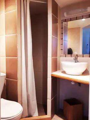 a bathroom with a sink and a toilet and a mirror at La Tiny House YourHostHelper in Narbonne