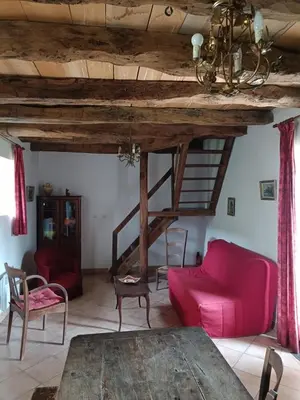 a living room with a red couch and a table at Domaine Puy Saint Jammes in Castres