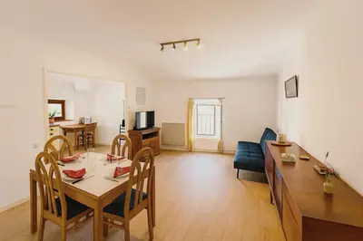 a living room with a table and a dining room at Appartement 2 chambres avec baignoire Lavelanet in Lavelanet