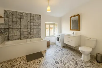 a bathroom with a tub and a toilet and a sink at Appartement 2 chambres avec baignoire Lavelanet in Lavelanet
