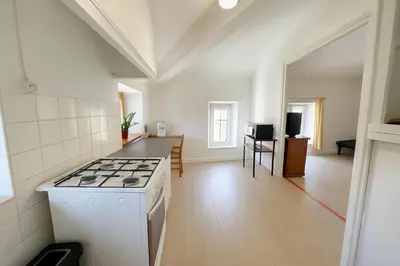 a kitchen with a stove top oven in a room at Appartement 2 chambres avec baignoire Lavelanet in Lavelanet