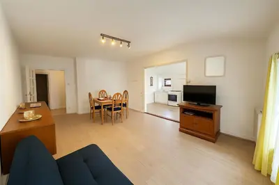 a living room with a couch and a table and a television at Appartement 2 chambres avec baignoire Lavelanet in Lavelanet