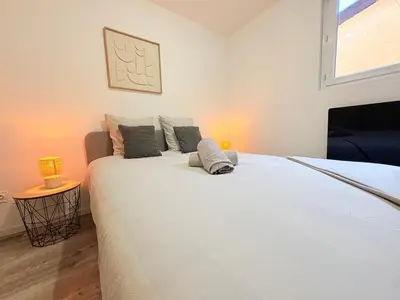 a bedroom with a large white bed with pillows at L'Écho du Castella in Pamiers
