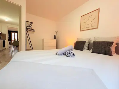 a bedroom with a large white bed with two pillows at L'Écho du Castella in Pamiers