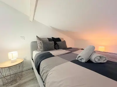 a bedroom with a large bed in a room at Le Refuge du Midi in Pamiers