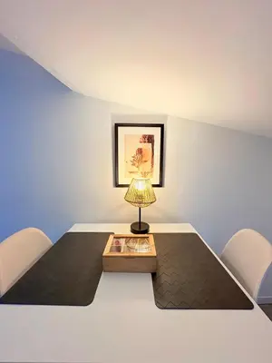 a table with a lamp sitting on top of it at Le Refuge du Midi in Pamiers
