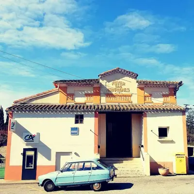 a blue car parked in front of a building at Le Beau Coin in Serviès-en-Val