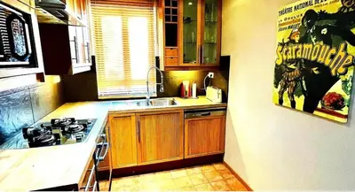 a kitchen with a sink and a stove top oven at Le Beau Coin in Serviès-en-Val