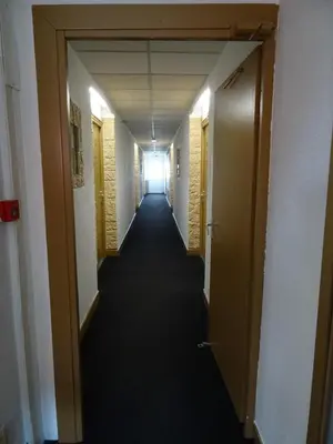 a hallway of an office building with a long corridor at Le Mazagan in Port-la-Nouvelle