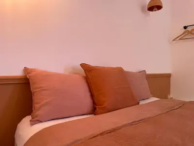 a bed with three pillows on top of it at Villa avec piscine privée - Capestang in Capestang