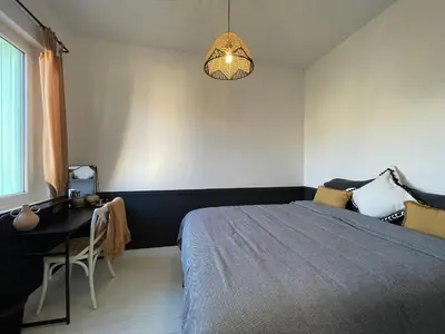 a bedroom with a bed and a desk and a lamp at Villa avec piscine privée - Capestang in Capestang