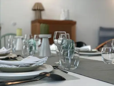 a table with wine glasses and plates on it at Villa avec piscine privée - Capestang in Capestang