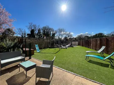 a yard with chairs and a playground with a swing at Évasion ensoleillée avec jacuzzi à Cazedarnes in Cazedarnes