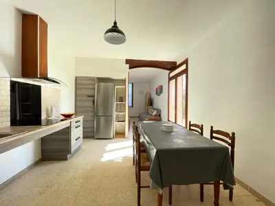a kitchen and dining room with a table and chairs at Évasion ensoleillée avec jacuzzi à Cazedarnes in Cazedarnes