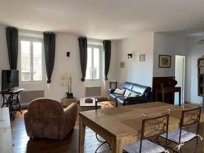 a living room with a table and chairs at La Maison Des Vendangeurs in Villesèque-des-Corbières