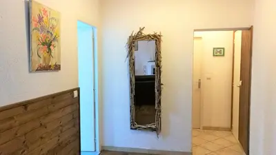 a mirror hanging on a wall in a room at La Maison Des Vendangeurs in Villesèque-des-Corbières