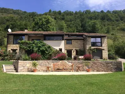 a stone house with a bench in front of it at Las Coumeilles in Leychert